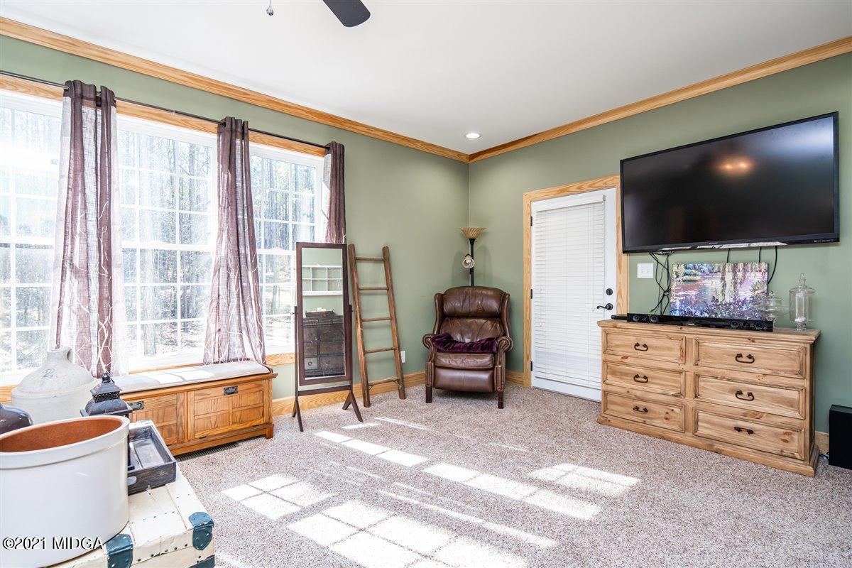 725 Taylor Road Juliette, GA 31046 - Photo 26 of 62 a living room with furniture and a flat screen tv