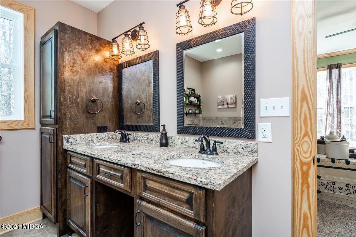 725 Taylor Road Juliette, GA 31046 - Photo 27 of 62 a bathroom with a granite countertop sink and a mirror