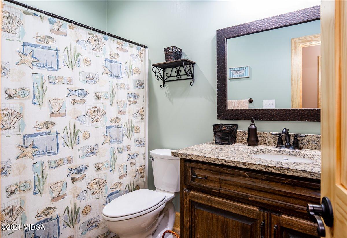 725 Taylor Road Juliette, GA 31046 - Photo 31 of 62 a bathroom with a granite countertop sink toilet and mirror