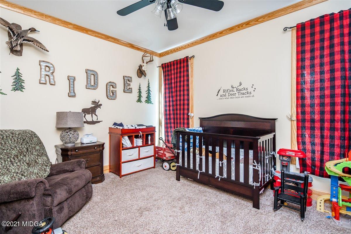 725 Taylor Road Juliette, GA 31046 - Photo 32 of 62 a bedroom with furniture and a baby crib