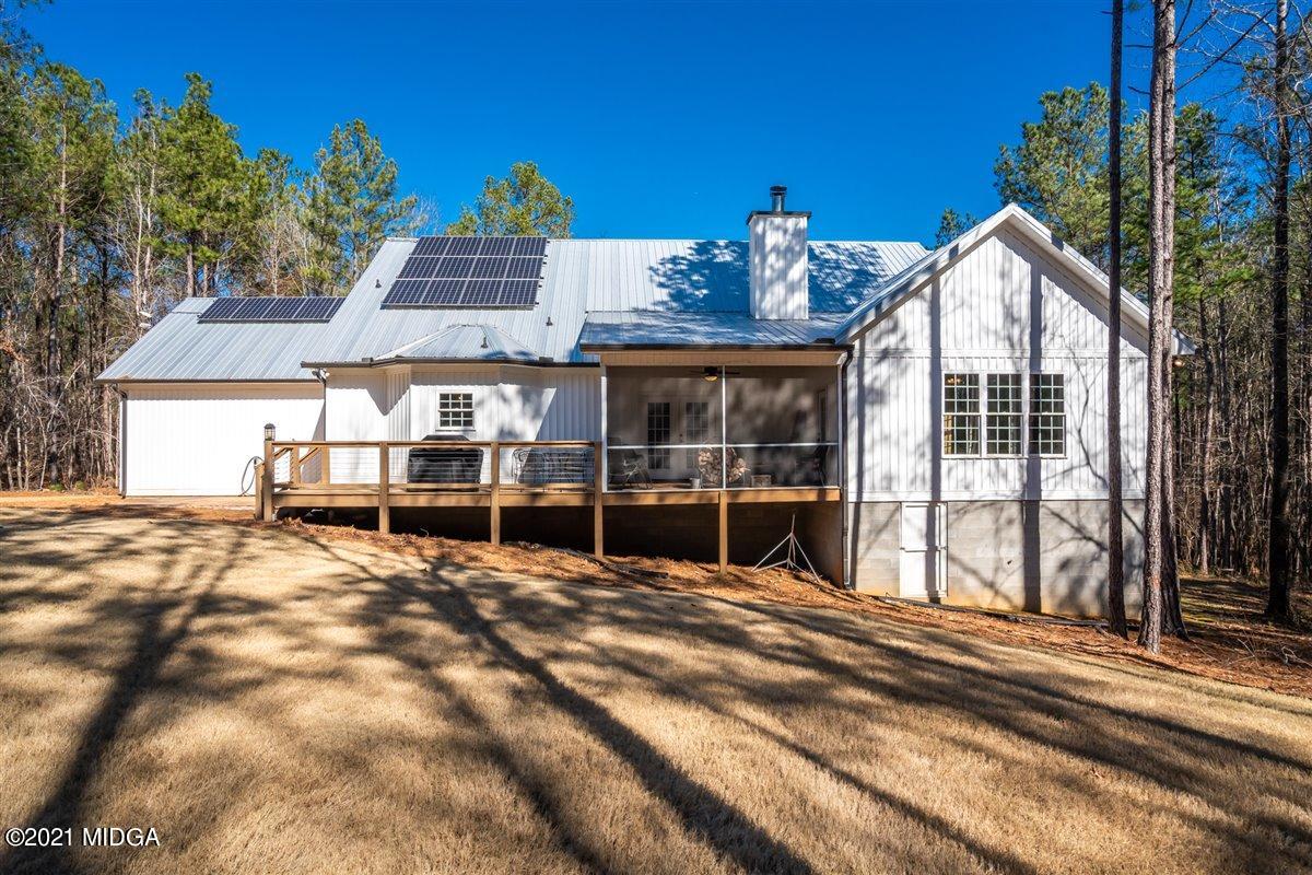 725 Taylor Road Juliette, GA 31046 - Photo 38 of 62 a view of a house with a large window and wooden fence
