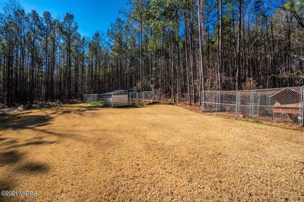 725 Taylor Road Juliette, GA 31046 - Photo 41 of 62 a view of swimming pool with small yard and trees in the background