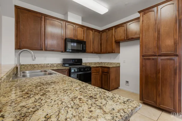 a stove top oven sitting inside of a kitchen