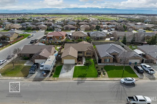 a house view with swimming pool and garden space
