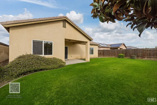 an aerial view of a house a yard and outdoor seating