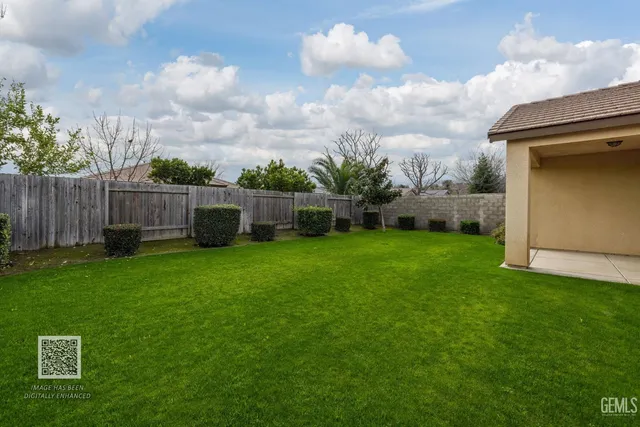 an aerial view of a city with lots of residential buildings ocean and mountain view in back