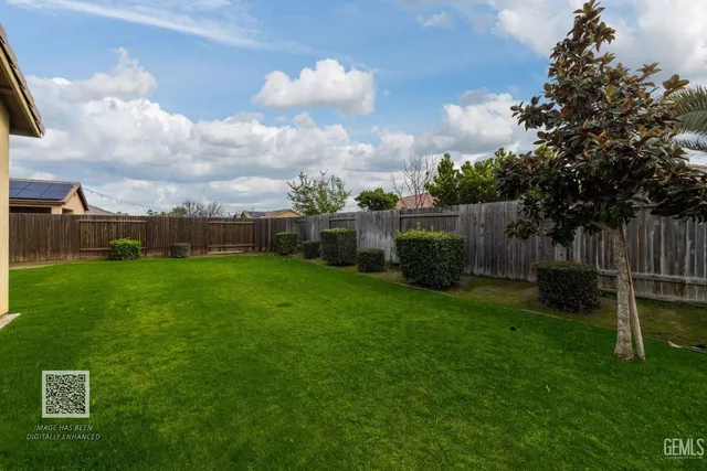an aerial view of a house with pool yard and outdoor seating