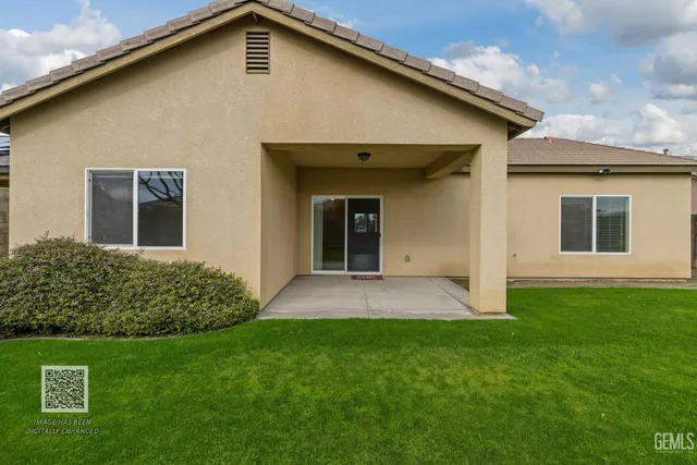 a view of a livingroom with furniture and chandelier fan