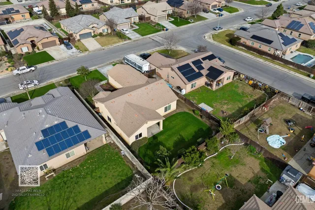 an empty room with windows and chandelier fan