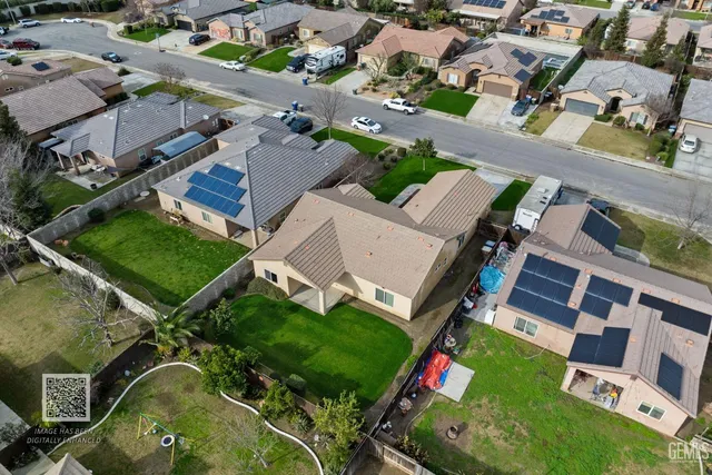 a kitchen with stainless steel appliances granite countertop a refrigerator oven a sink dishwasher a stove and a refrigerator with wooden floor