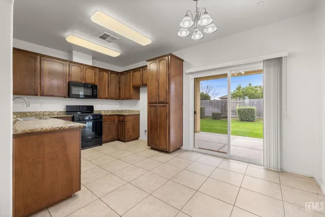 an empty room with a window and a ceiling fan