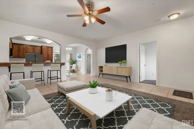 a kitchen with stainless steel appliances granite countertop a stove a refrigerator a kitchen island a dining table and chairs