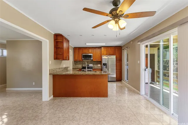 a large kitchen with stainless steel appliances granite countertop a stove and a refrigerator