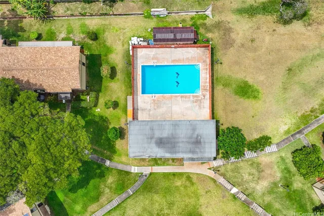 a view of a swimming pool and a yard