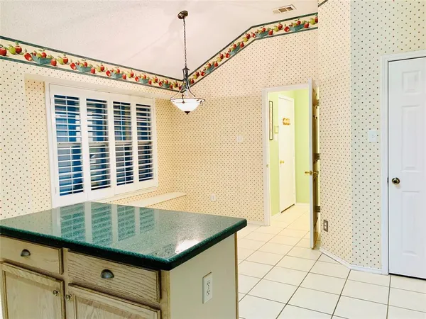 a bathroom with a granite countertop sink a mirror and shower