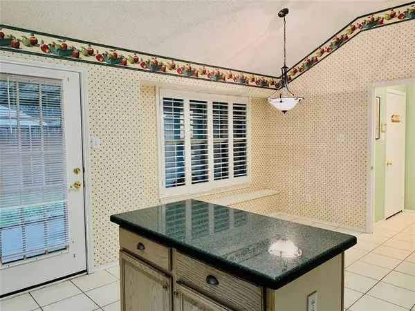 a kitchen with granite countertop a sink and a window