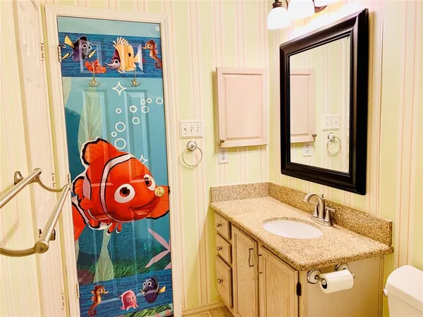 a bathroom with a granite countertop sink and a mirror