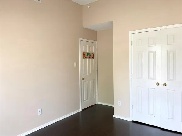 an empty room with wooden floor