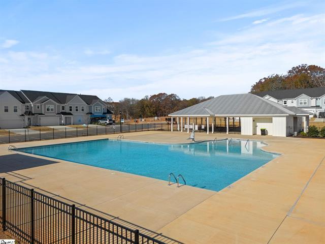 Relax and unwind in the community pool, surrounded by scenic views and modern amenities.