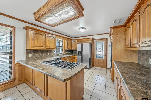 a kitchen with stainless steel appliances granite countertop a sink stove and cabinets