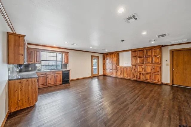 a view of a room with a ceiling fan and window