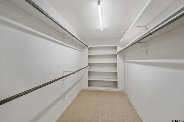 a bathroom with a granite countertop sink a large mirror a bathtub and shower
