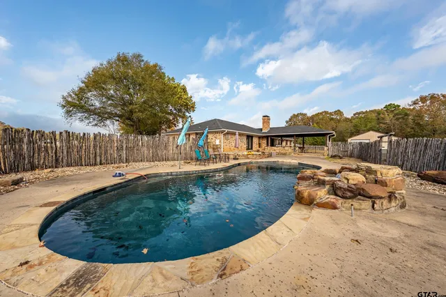 a view of a backyard with a large tree
