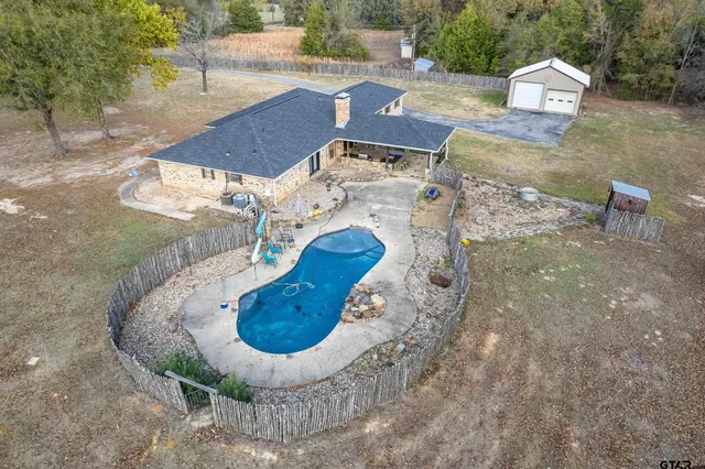 a front view of a house with a yard and lake view