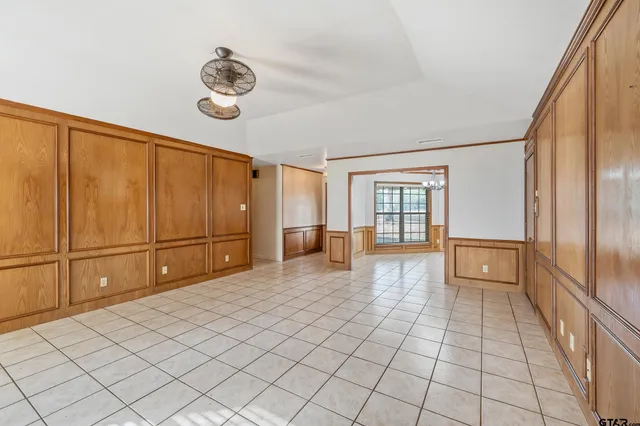 a view of an empty room with a fireplace and a window