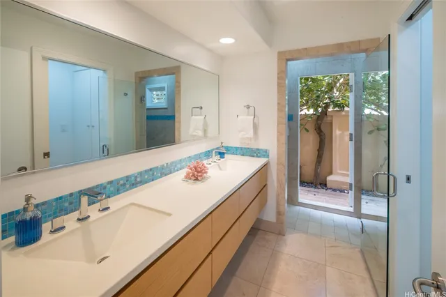 a bathroom with a granite countertop sink a mirror and a bathtub