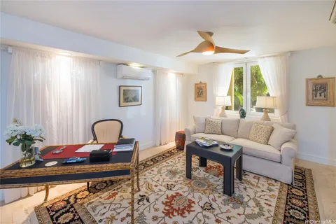 a living room with furniture and a potted plant
