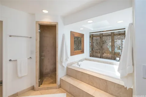 a bathroom with a large tub and shower