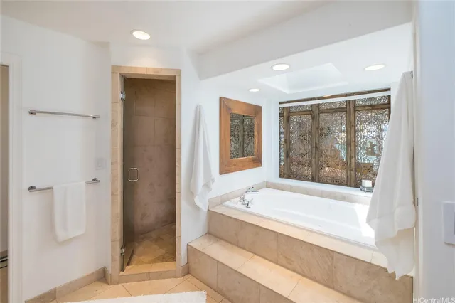 a bathroom with a large tub and shower