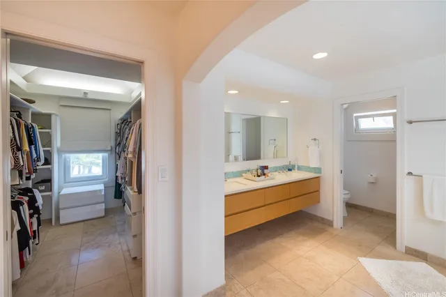 a bathroom with a tub sink shower and mirror