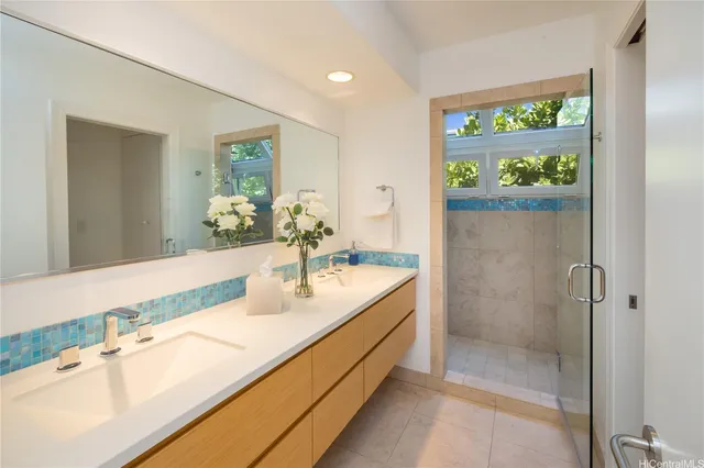 a bathroom with a double vanity sink and a mirror