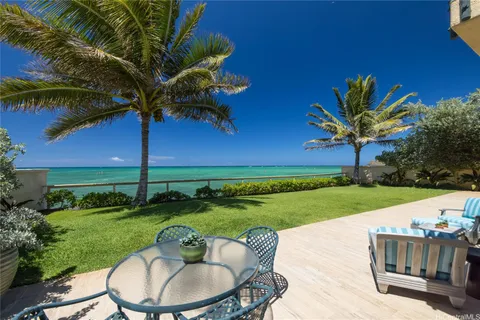 a backyard of a house with a garden and barbeque oven