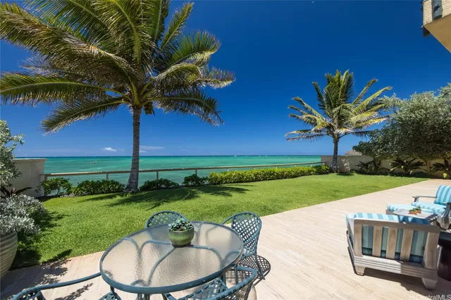 a backyard of a house with a garden and barbeque oven