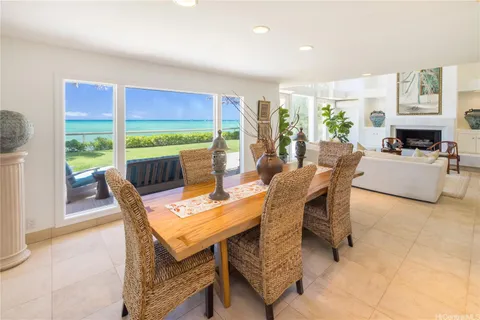 a dining room with furniture and a floor to ceiling window