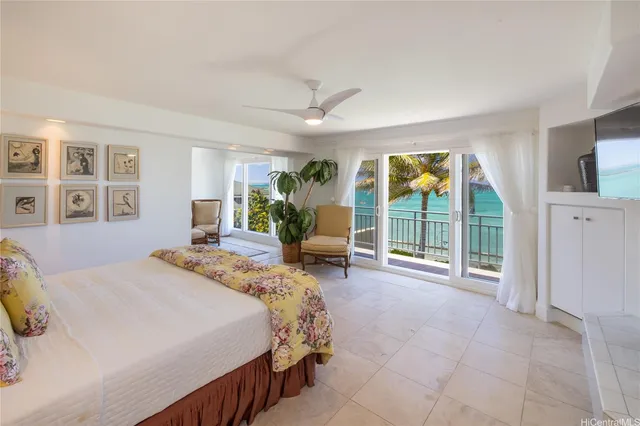 a spacious bedroom with a large bed and a large window