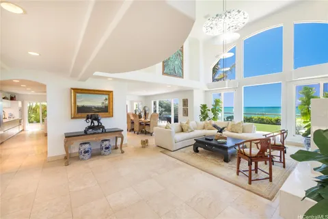 a living room with furniture chandelier and a large window