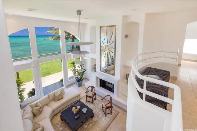 a living room with furniture fireplace and a large window