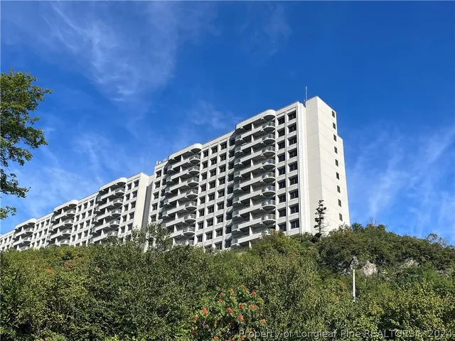 a view of a building in the middle of a field