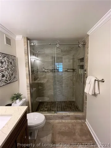 a bathroom with a toilet and a shower