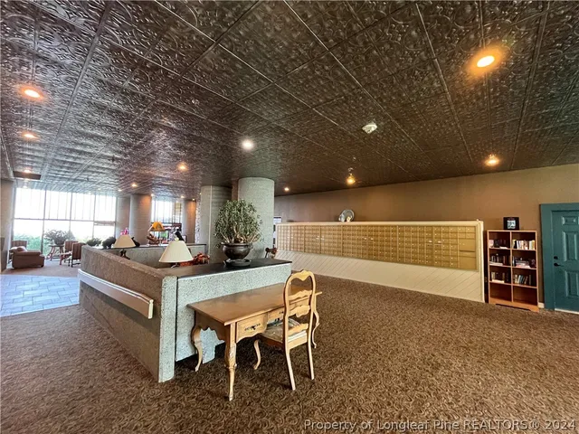 a view of a patio with couches table and chairs and potted plants