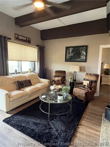 a kitchen with kitchen island granite countertop wooden cabinets a stove and a sink