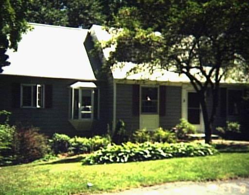1 Marcardon Avenue Ridgefield, CT 06877 - Photo 1 of 1 a front view of a house with a yard and potted plants