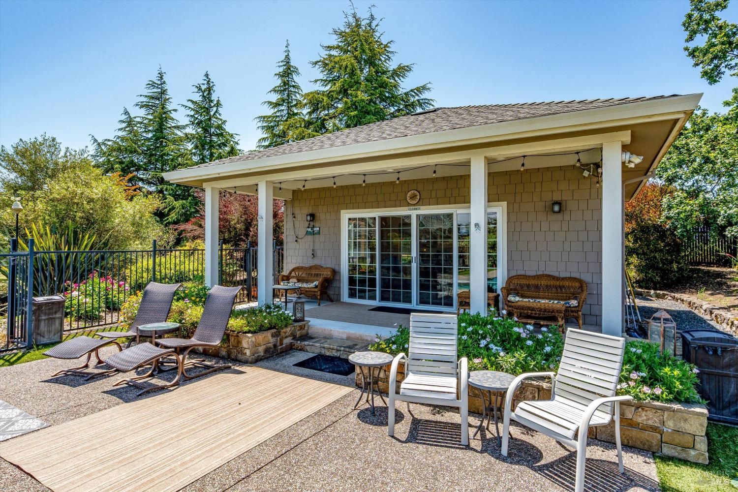 4760 Blank Road Sebastopol, CA 95472 - Photo 14 of 46 a view of a patio with table and chairs potted plants and floor to ceiling window