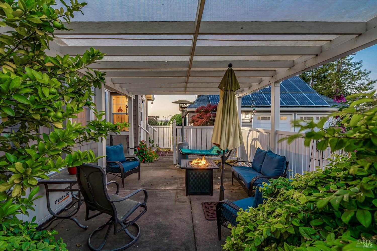 4760 Blank Road Sebastopol, CA 95472 - Photo 35 of 46 a view of a patio with table and chairs potted plants and floor to ceiling window and potted plants