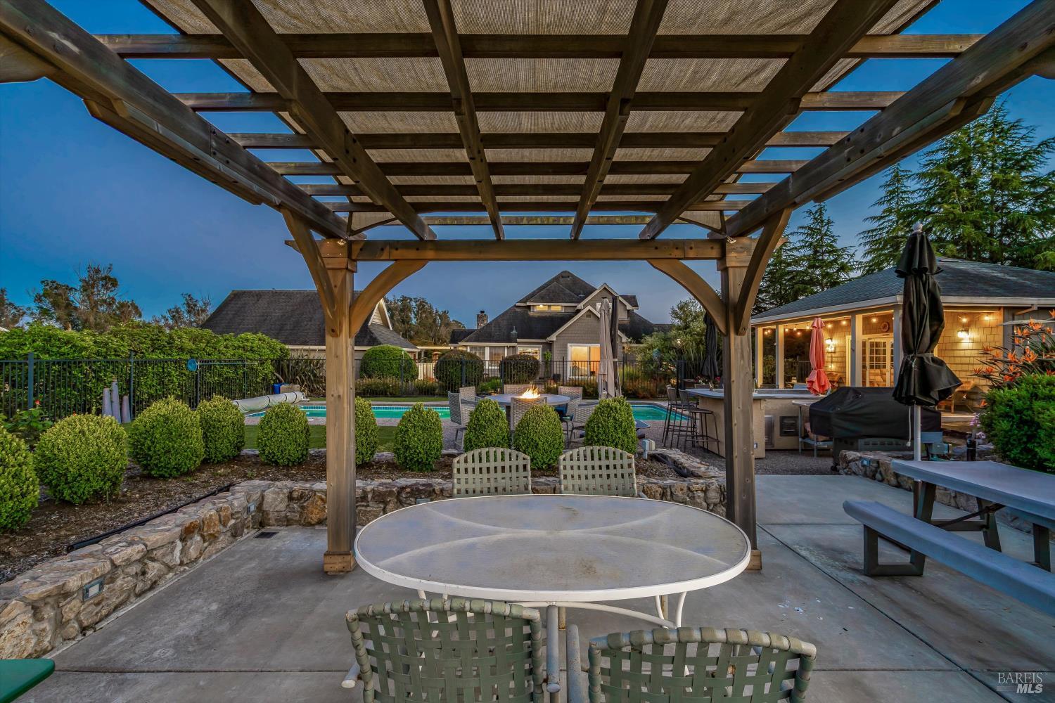 4760 Blank Road Sebastopol, CA 95472 - Photo 37 of 46 a backyard of a house with fountain table and chairs