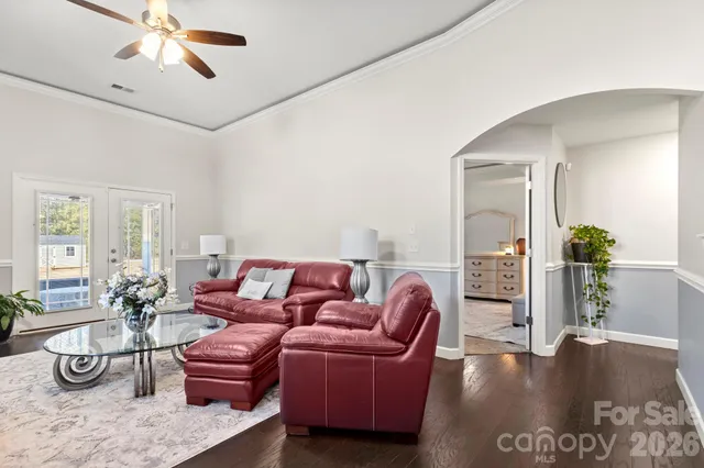 a living room with furniture and a chandelier